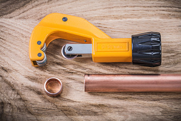 Set of copper water pipe scissors on wooden board plumbing brass