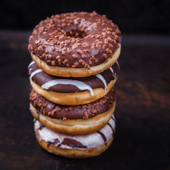 Donuts in colored glazes on a dark background.Pastries,dessert.selective focus.