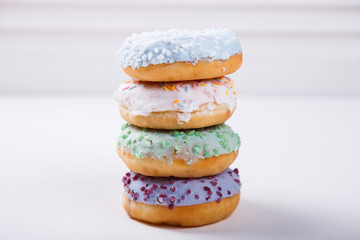 Donuts in colored glazes on a white background.Pastries,dessert.selective focus.