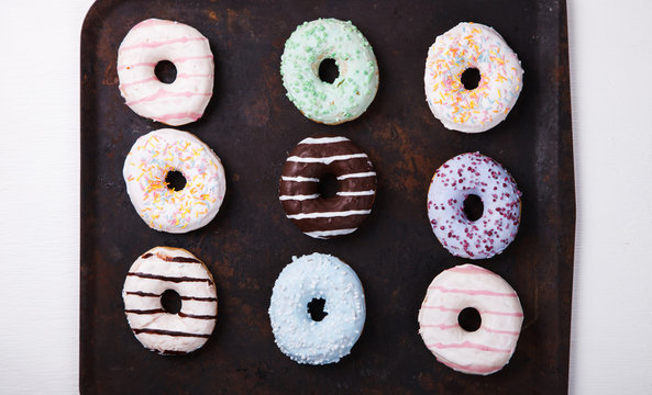 Donuts in colored glazes on a dark background.Pastries,dessert.selective focus.