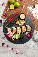 Japanese dumplings, which are located next to the vegetables and soy sauce, the view from the top
