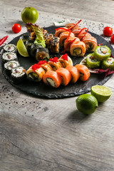 Big sushi set, the hand that holds the chopsticks, the view from the top