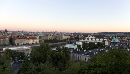 Fototapeta na wymiar Evening Prague City with its Bridges and Towers above River Vltava, Czech Republic