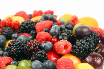 lots of fresh different berries on a white background