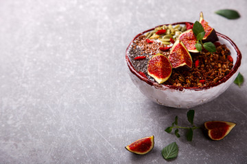Granola with yogurt, Chia seeds,Goji berries,pumpkin seeds, fresh figs and honey.A vegetarian Breakfast.Food or Healthy diet concept.Copy space. selective focus.