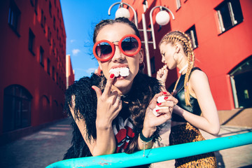 female models in vintage cloth eating sweats, marshmallows