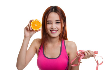 Asian healthy girl on diet with orange fruit and measuring tape.