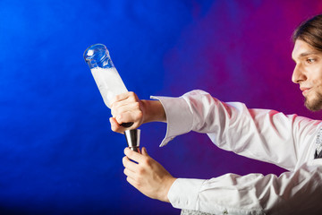 Bartender pouring liquor into glass.