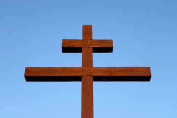 Orthodox cross on blue sky.