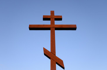 Orthodox cross on blue sky.