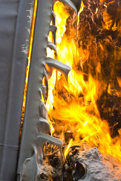 Detail of plastic container burning and melted by fire
