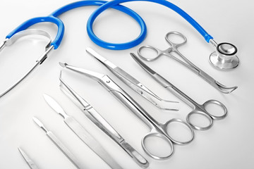 Flat lay of surgery instruments on white background