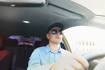 Male taxi driver in car