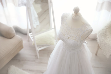 Fototapeta na wymiar Made-up wedding dress on mannequin in studio