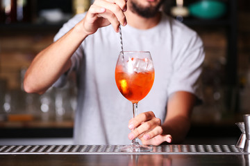 Barman preparing cocktail on bar counter