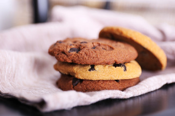 Fresh oat biscuits with chocolate on napkin, closeup