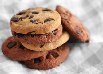 Fototapeta na wymiar Fresh oat biscuits with chocolate on fabric background