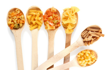 Wooden spoons with pasta, isolated on white