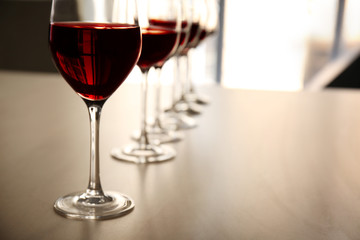 Glasses of red wine on table in restaurant