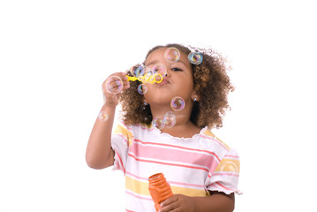 Little girl blowing bubbles