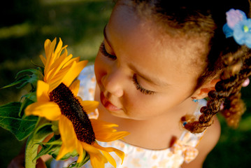Little girl with a sunflower