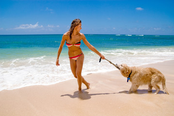 Woman on the beach with a dog