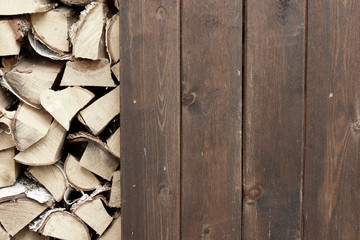 Wooden wall near stack of firewood.