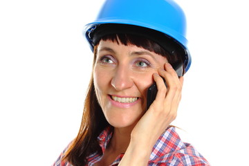 Builder woman in protective helmet talking on mobile phone