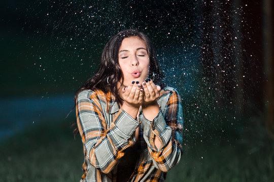 Teenage Girl Caucasian Blowing Glitter From Her Hands Sitting