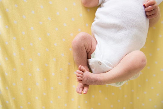 newborn baby on yellow blanket 