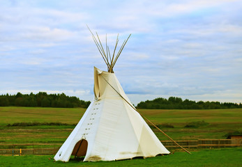 White wigwam on green field © PixieMe
