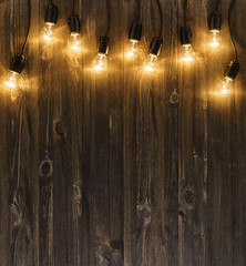 Light bulbs on dark wooden background