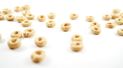 Whole weat circular cereal Os on white background