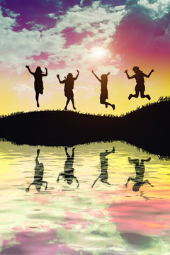 silhouette of Group of Hipster Teenagers Jumping at the Sunset