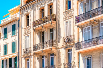 Fototapeta na wymiar Beautiful residential buildings with colonial architecture in Cannes city in French riviera.