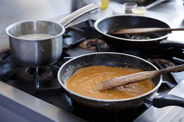 Curry soup is cooked in a pan.