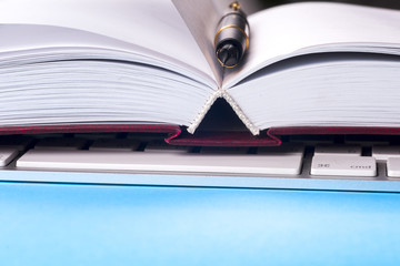 Close-up of open book and pen.