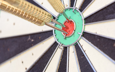 Three Bullseye Darts on a Dart Board
