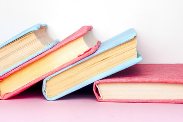 Stack of colorful books, grungy blue background, free copy space
