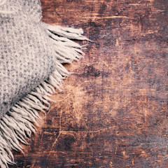 Winter concept style Card - knitted wool scarf over wooden backg