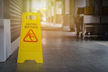 Sign showing warning of caution wet floor,selective focus,vintage color.