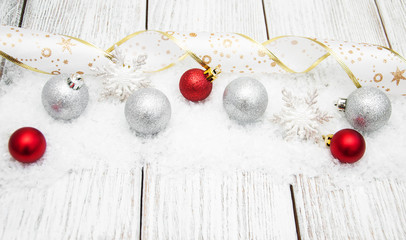 christmas balls with ribbon on snow