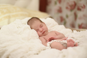 Fototapeta na wymiar Newborn sweet cute baby girl face sleep