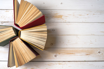 Top view of bright colorful hardback books in a circle.