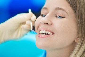 Obraz premium Close-up of female with open mouth during oral checkup at the dentist.Dentist