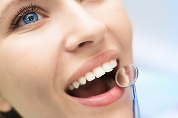 Close-up of female with open mouth during oral checkup at the dentist.Dentist