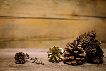 Different cones on old wooden table, wooden background