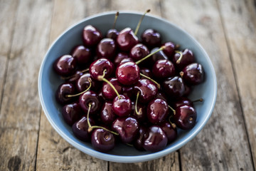 Red cherries in antique bowl