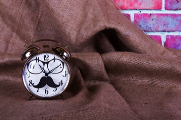 Alarm clock with a black hipster mustache