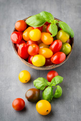 Tomatoes an gray background. Colorful tomatoes, red tomatoes, ye